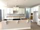 Bright, open kitchen area featuring white cabinets and an unfinished kitchen island at 3200 Balcon Ct # 28, Angier, NC 27501