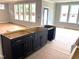 Bright, open living room area featuring large windows and an unfinished kitchen island at 3200 Balcon Ct # 28, Angier, NC 27501