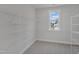 Large walk-in closet featuring wire shelves and carpeted floor at 3200 Balcon Ct # 28, Angier, NC 27501