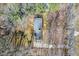 Aerial of the house with a dark roof surrounded by mature trees and a paved driveway at 350 W Lake Trl, Mebane, NC 27302