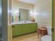 Full bathroom with green vanity and vintage wallpaper at 350 W Lake Trl, Mebane, NC 27302