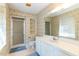 Bathroom with shower, mirror, wallpaper, and cabinet at 350 W Lake Trl, Mebane, NC 27302
