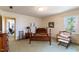 Spacious bedroom features a classic four-poster bed frame, side chair and ample natural light at 350 W Lake Trl, Mebane, NC 27302