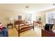 Bright bedroom with a bed frame, desk, and natural light from the windows at 350 W Lake Trl, Mebane, NC 27302