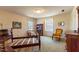 Sunlit bedroom boasts a four-poster bed frame, bright windows, and a comfortable sitting area at 350 W Lake Trl, Mebane, NC 27302