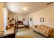 Bedroom space with a four poster bed frame, love seat, and neutral color palette at 350 W Lake Trl, Mebane, NC 27302