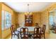 Dining room with wallpaper, large window, chandelier, and traditional furniture at 350 W Lake Trl, Mebane, NC 27302