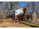 Back exterior view of a two-story brick home with multiple windows and access doors at 350 W Lake Trl, Mebane, NC 27302