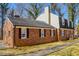 Charming brick home featuring black shutters, a black roof, and a well-maintained landscape at 350 W Lake Trl, Mebane, NC 27302