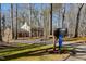 View of a quiet tree-lined driveway leading up to the home at 350 W Lake Trl, Mebane, NC 27302