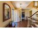 Inviting foyer featuring hardwood floors, a staircase, and a mirrored wall accent at 350 W Lake Trl, Mebane, NC 27302