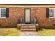 Charming home entrance with brick facade, complemented by black shutters and a well-manicured lawn at 350 W Lake Trl, Mebane, NC 27302