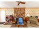 Living area showcasing a brick fireplace, chair, and built-in shelves at 350 W Lake Trl, Mebane, NC 27302