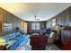 Spacious living room with a fireplace, wood paneling, and comfortable seating at 350 W Lake Trl, Mebane, NC 27302