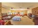 Spacious living room featuring a bed, fireplace, ceiling fans, and large windows at 350 W Lake Trl, Mebane, NC 27302