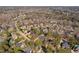 Expansive aerial view of a neighborhood with manicured lawns, mature trees, and community streets at 3905 Grandbridge Dr, Apex, NC 27539