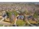 Aerial shot of a home in a wooded neighborhood with mature trees and manicured lawns at 3905 Grandbridge Dr, Apex, NC 27539