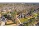Drone view of a home in wooded neighborhood, showcasing landscaping and manicured lawns at 3905 Grandbridge Dr, Apex, NC 27539