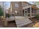 Backyard deck featuring a hot tub, steps to the yard and access to a screened-in porch at 3905 Grandbridge Dr, Apex, NC 27539