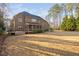 View of the brick home featuring a large backyard with patio and deck with hot tub at 3905 Grandbridge Dr, Apex, NC 27539