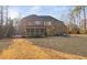 Expansive backyard with brick home, screened porch, deck with hot tub, and an outdoor dining area at 3905 Grandbridge Dr, Apex, NC 27539