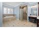A spacious bathroom with a glass block shower, soaking tub, and vanity at 3905 Grandbridge Dr, Apex, NC 27539
