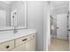 Modern bathroom featuring a stylish vanity and sink, leading to a glass-enclosed shower at 3905 Grandbridge Dr, Apex, NC 27539