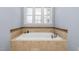 Luxurious bathroom with a large soaking tub and elegant fixtures, perfect for relaxation at 3905 Grandbridge Dr, Apex, NC 27539