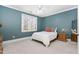 Serene bedroom with a cozy window view, complemented by a stylish bedside table at 3905 Grandbridge Dr, Apex, NC 27539