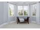 This sitting area offers windows with beautiful views, a comfortable seat, and white, flowing curtains at 3905 Grandbridge Dr, Apex, NC 27539