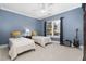 This bedroom features two twin beds, a ceiling fan, and a window with natural light at 3905 Grandbridge Dr, Apex, NC 27539