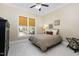 Neutral bedroom features a ceiling fan, window with view, and plush carpeting at 3905 Grandbridge Dr, Apex, NC 27539