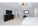 This main bedroom offers ample space, with a television, dresser and mirror, and comfortable seating at 3905 Grandbridge Dr, Apex, NC 27539