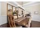 Traditional dining room features hardwood floors, modern light fixture, and decorative mirrors at 3905 Grandbridge Dr, Apex, NC 27539