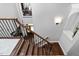 Stairway features dark hardwood steps and white risers with decorative iron railing at 3905 Grandbridge Dr, Apex, NC 27539