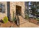 Inviting front entrance with brick steps, wrought iron railing, and stone accents at 3905 Grandbridge Dr, Apex, NC 27539