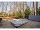 Outdoor hot tub on a wooden deck, overlooking a serene wooded landscape for peaceful relaxation at 3905 Grandbridge Dr, Apex, NC 27539