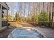 Inviting hot tub nestled on a wooden deck with wooded views, providing privacy and relaxation at 3905 Grandbridge Dr, Apex, NC 27539