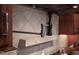 Close up of a pot filler faucet and tiled backsplash behind a gas range in a gourmet kitchen at 3905 Grandbridge Dr, Apex, NC 27539