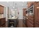 Beautiful kitchen with large island, granite counters, stainless appliances, and dark wood floors; a modern culinary delight at 3905 Grandbridge Dr, Apex, NC 27539
