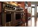 Gourmet kitchen featuring a large gas range, stainless steel appliances, granite counters, and custom cabinetry at 3905 Grandbridge Dr, Apex, NC 27539