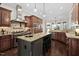 Spacious kitchen features a large island, stainless steel appliances, and custom cabinetry, creating a chef-inspired culinary space at 3905 Grandbridge Dr, Apex, NC 27539