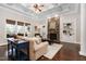 Bright living room featuring hardwood floors, fireplace, coffered ceiling, and natural light at 3905 Grandbridge Dr, Apex, NC 27539