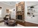 Comfortable living room featuring a stone fireplace, built-ins, and coffered ceilings at 3905 Grandbridge Dr, Apex, NC 27539