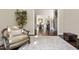 Inviting living room with cozy armchair, hardwood floors, and view into the dining room at 3905 Grandbridge Dr, Apex, NC 27539