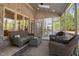 This beautiful screened porch features brick walls, wicker furniture, and natural light at 3905 Grandbridge Dr, Apex, NC 27539