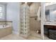Elegant bathroom featuring a tiled walk-in shower with glass block surround at 3905 Grandbridge Dr, Apex, NC 27539