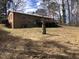 View of a backyard featuring a raised wood deck and a large yard with mature trees at 4032 Chaucer Dr, Durham, NC 27705