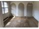 A bedroom with unfinished walls and floors, featuring a window that allows natural light at 4032 Chaucer Dr, Durham, NC 27705