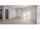 Bright bedroom featuring neutral carpet, a window, and a door, perfect for a cozy retreat at 44 Black Creek Dr, Lillington, NC 27546